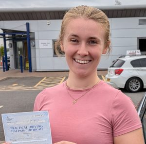 Holly holding her driving test pass certificate