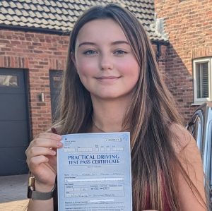 Maddison holding her pass certificate