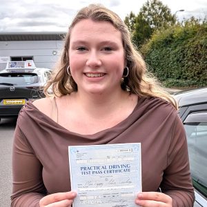 Connie holding her driving test pass certificate