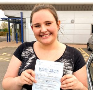Connie holding her driving test pass certificate